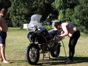 Jacques cleaning his bike for the trip back